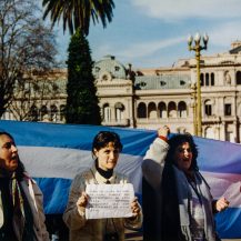 <p>Demonstrators from the province of Corrientes took their case to the presidential palace on Buenos Aires' Plaza de Mayo. They were part of broad-based civic movement spearheaded by teachers who were protesting unpaid wages, deteriorating quality of life, and corruption concerns in their provincial government in 1999 – in many ways precursors to the broader meltdown that ravaged Argentina in 2001.</p><p>Her sign reads, 'My struggle will not be in vain, as I am a part of this new history of Corrientes, which I will proudly bring to the classrooms'.</p>