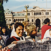 <p>Members of the Madres de la Plaza de Mayo carry a banner displaying portraits of their relatives disappeared by Argentina's military junta of 1976-1983. <br /></p>
<p>Mothers, grandmothers, and other relatives began these marches during the dictatorship, gathering each Thursday at the Plaza de Mayo to demand accountability and justice for their missing loved ones. Their movement adopted the name of the square. <br /></p>
<p>This photo was taken in 1999, 22 years after they had commenced their rallies. They continue marching to this day.</p>