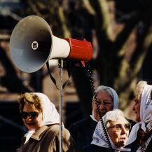 <p>Some of the Madres de la Plaza de Mayo prepare to air their calls for justice directly at the presidential palace in Buenos Aires. Their intense expressions match the determination they have shown in their decades-long struggle for accountability.</p>