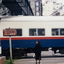 <p>A woman waits at a level crossing in Buenos Aires.</p>