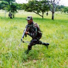 <p>A Colombian Army soldier charges ahead. </p>