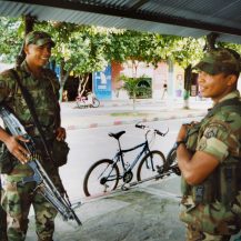 <p>Two soldiers guard a street corner in central Tame, a town in Colombia's war-ravaged Arauca department. Their presence was part of an attempt to hold the town after it was reclaimed from guerrillas. <br /></p><p>They are laughing at a joke my colleague made about the relative size of their weapons – indeed, the US M60 carried by the soldier at left is a hefty machine gun often fired by a team of two or three gunners, while the soldier at right carries a more standard-issue Galil, an Israeli derivative of the infamous Soviet/Russian AK-47. </p>