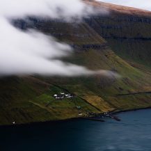 <p>Clouds cling to the contours of Kalsoy island, closing in on the tiny village of Syðradalur.</p>