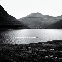 <p>A boat navigates the Funningsfjørður, a deep fjord that cuts through the island of Eysturoy.</p>