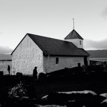 <p>A pair of visitors to the cemetery at St. Olaf's Church, a small and centuries-old parish.</p>