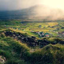 <p>A view over the village of Fámjin. The structure in the foreground, slowly being reclaimed by the grass, is a stone sheep shelter.</p>