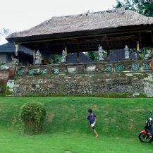 <p>A boy runs around the grounds of Pura Taman Ayun, a Hindu temple.</p>