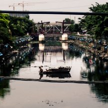 <p>A man in his boat in a Jakarta canal.</p>