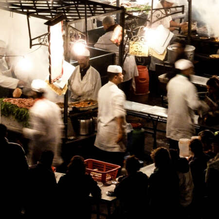 <p>Marrakech's Jamaa el Fna is a central square that constantly whirls with activity. Here, cooks prepare meals at the lively food stalls.</p>