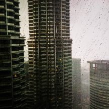 <p>Diffused light and swirling rain interplay with the unique contours of the Petronas Towers.</p>