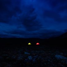 <p>Darkness envelopes two tents in the Norwegian wilderness.</p>