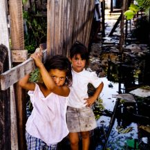 <p>Two girls explore their flood-damaged former neighbourhood just behind the national congress on the banks of the Paraguay River. Their homes were flooded a few weeks before Christmas in 1997, forcing their already struggling families to relocate to makeshift residences in a public square.</p>