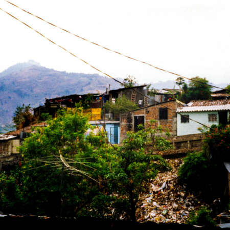 <p>A cluster of makeshift homes on the outskirts of San Salvador. Such homes represent years of effort by their inhabitants, but often these neighbourhoods lack essential services like plumbing, refuse collection, and official recognition of the residents' title to their land. These districts are peripheries not only in the geographical sense, but also in terms of political and economic attention.</p>