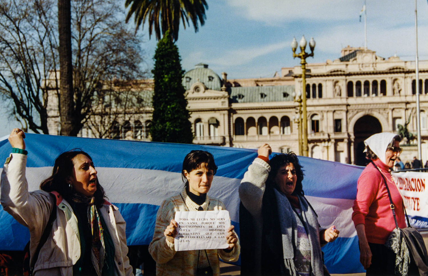 <p>Demonstrators from the province of Corrientes took their case to the presidential palace on Buenos Aires' Plaza de Mayo. They were part of broad-based civic movement spearheaded by teachers who were protesting unpaid wages, deteriorating quality of life, and corruption concerns in their provincial government in 1999 – in many ways precursors to the broader meltdown that ravaged Argentina in 2001.</p><p>Her sign reads, 'My struggle will not be in vain, as I am a part of this new history of Corrientes, which I will proudly bring to the classrooms'.</p>