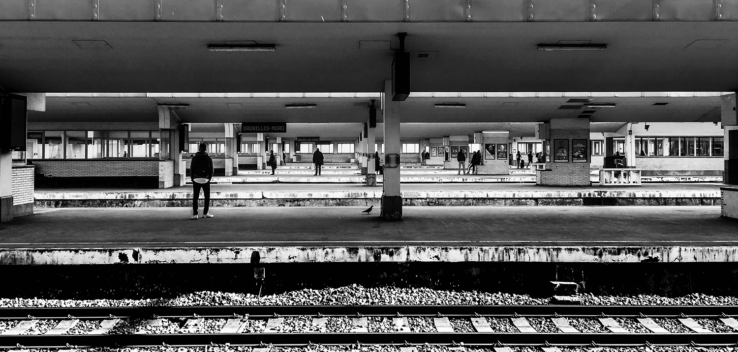 <p>Passengers wait on the perfectly parallel platforms of Bruxelles-Nord station.</p>