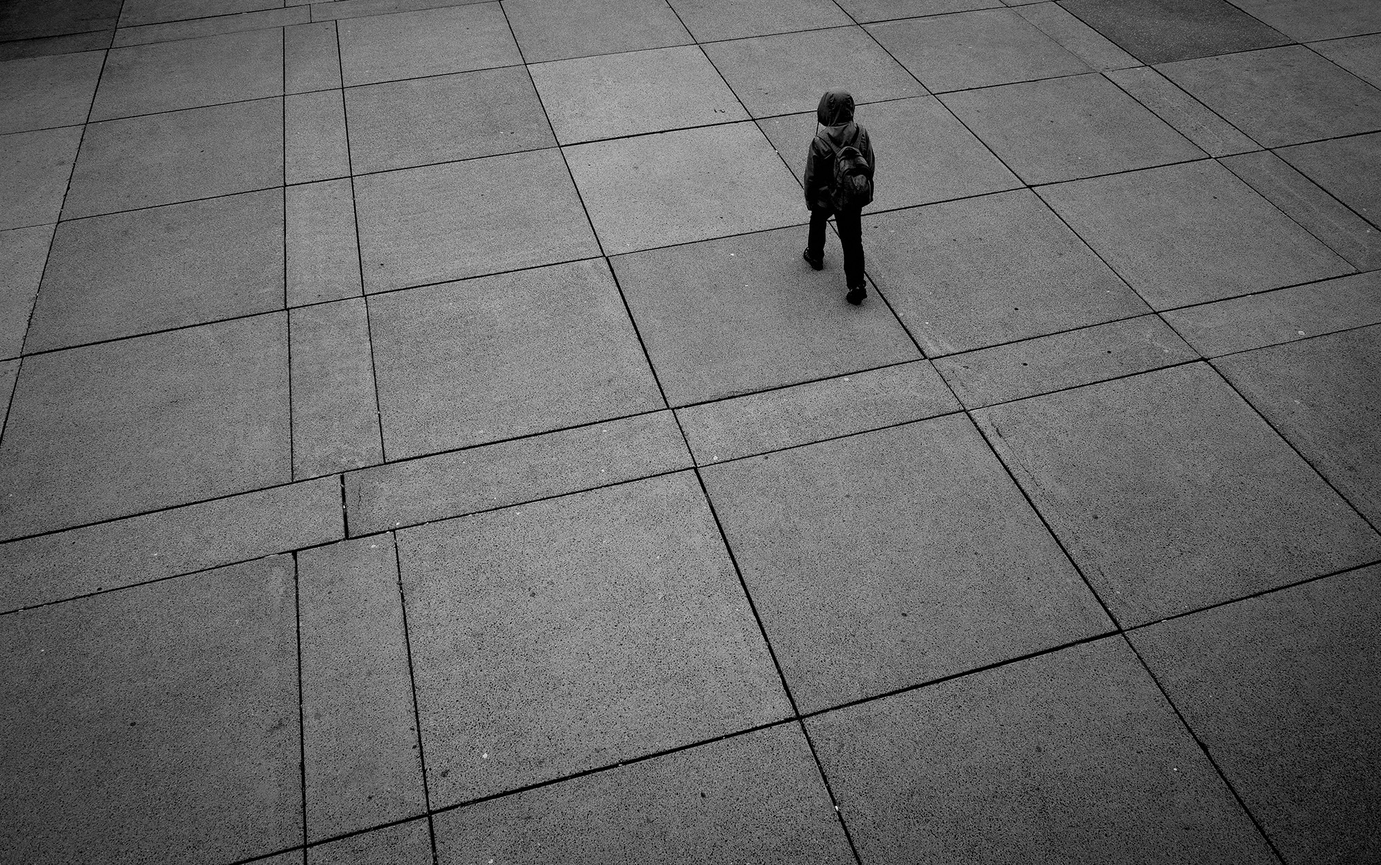 <p>A person crossing a plaza in Toronto.<br /></p>