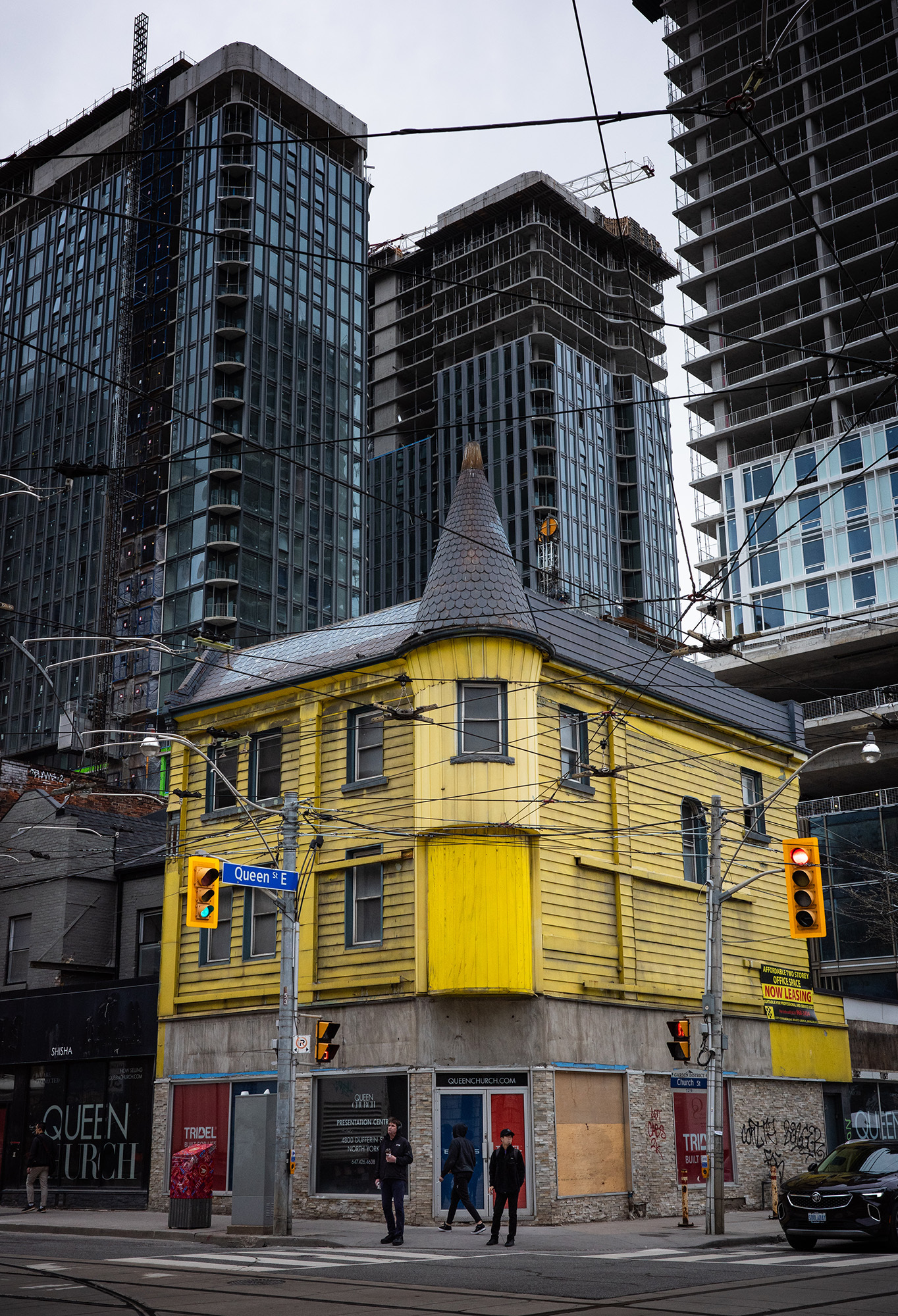 <p>New high-rises crowd a more traditional Toronto building at the corner of Queen and Church streets.</p>