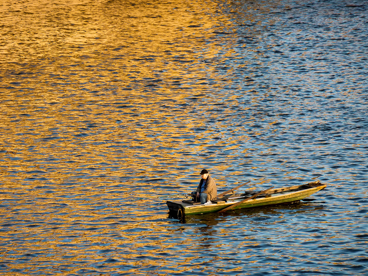 <p>A contemplative fisherman in the heart of Zlatá Praha.</p>