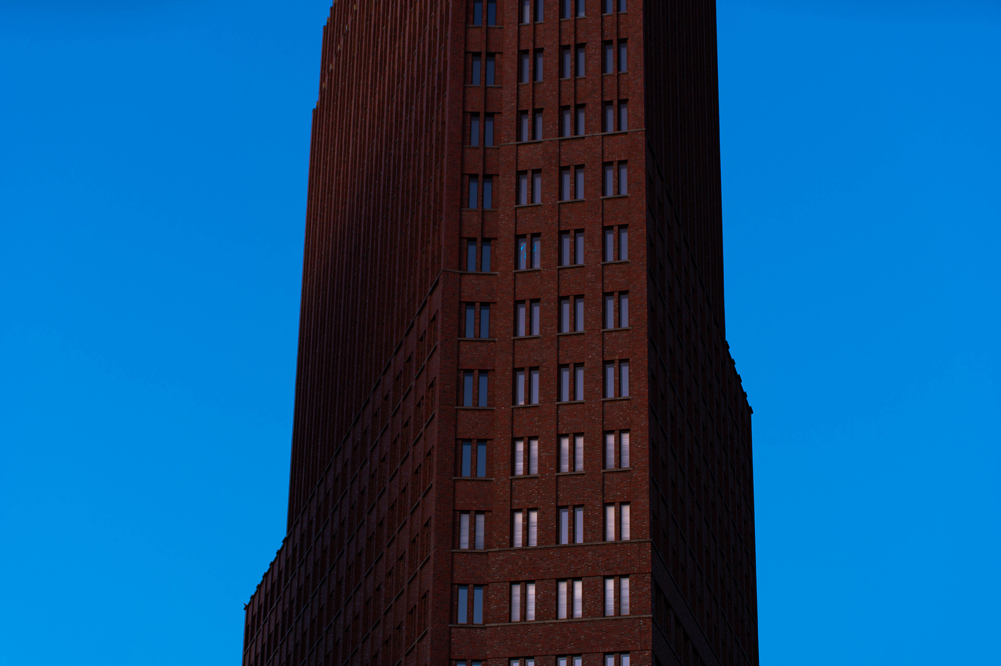 <p>A view of the Kollhoff Tower, a distinctive skyscraper occupying a sharply angular corner at Berlin's Potsdamer Platz.</p>