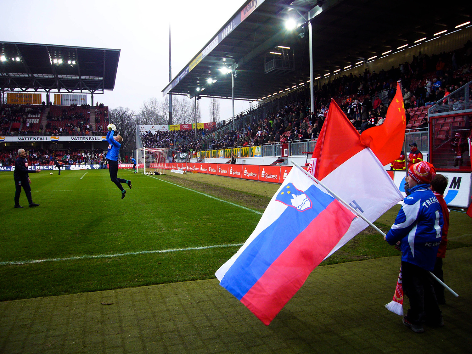 <p>Flagbearers watching the warm-ups at a 2009 match between Energie Cottbus and Hertha BSC in the Stadion der Freundschaft.<br /></p>
