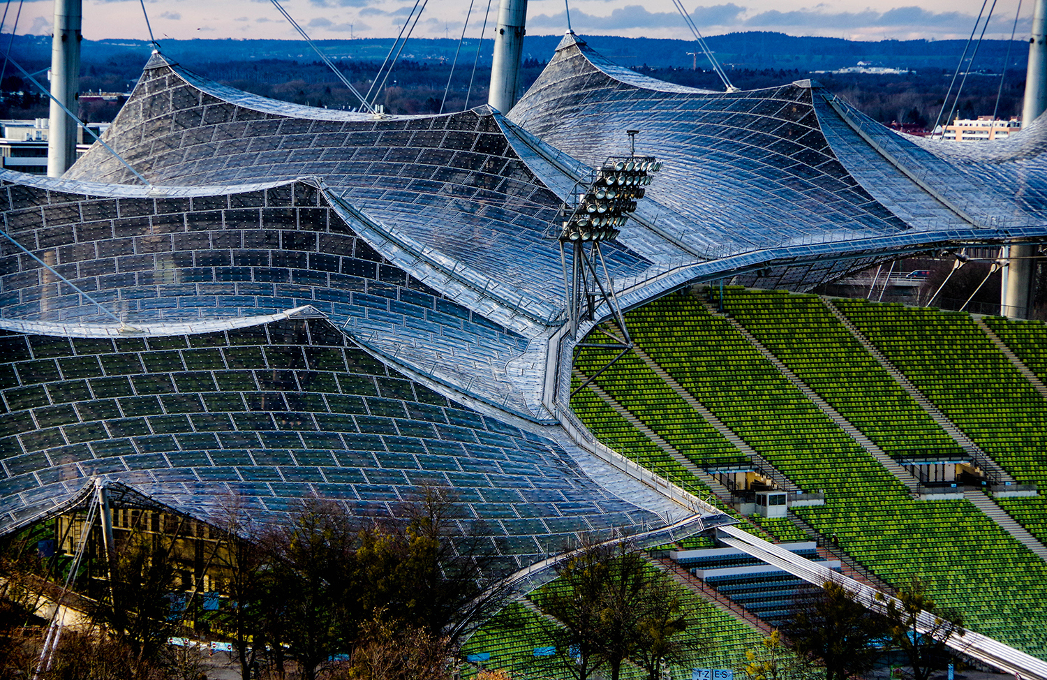 <p>The unique contours of the Munich Olympic Stadium, designed by architect Günther Behnisch and engineer Frei Otto for the summer games of 1972. The famous suspended roof — a vast tent of glass panels held aloft by steel cables and pillars — still looks futuristic almost 50 years after it was erected. </p>