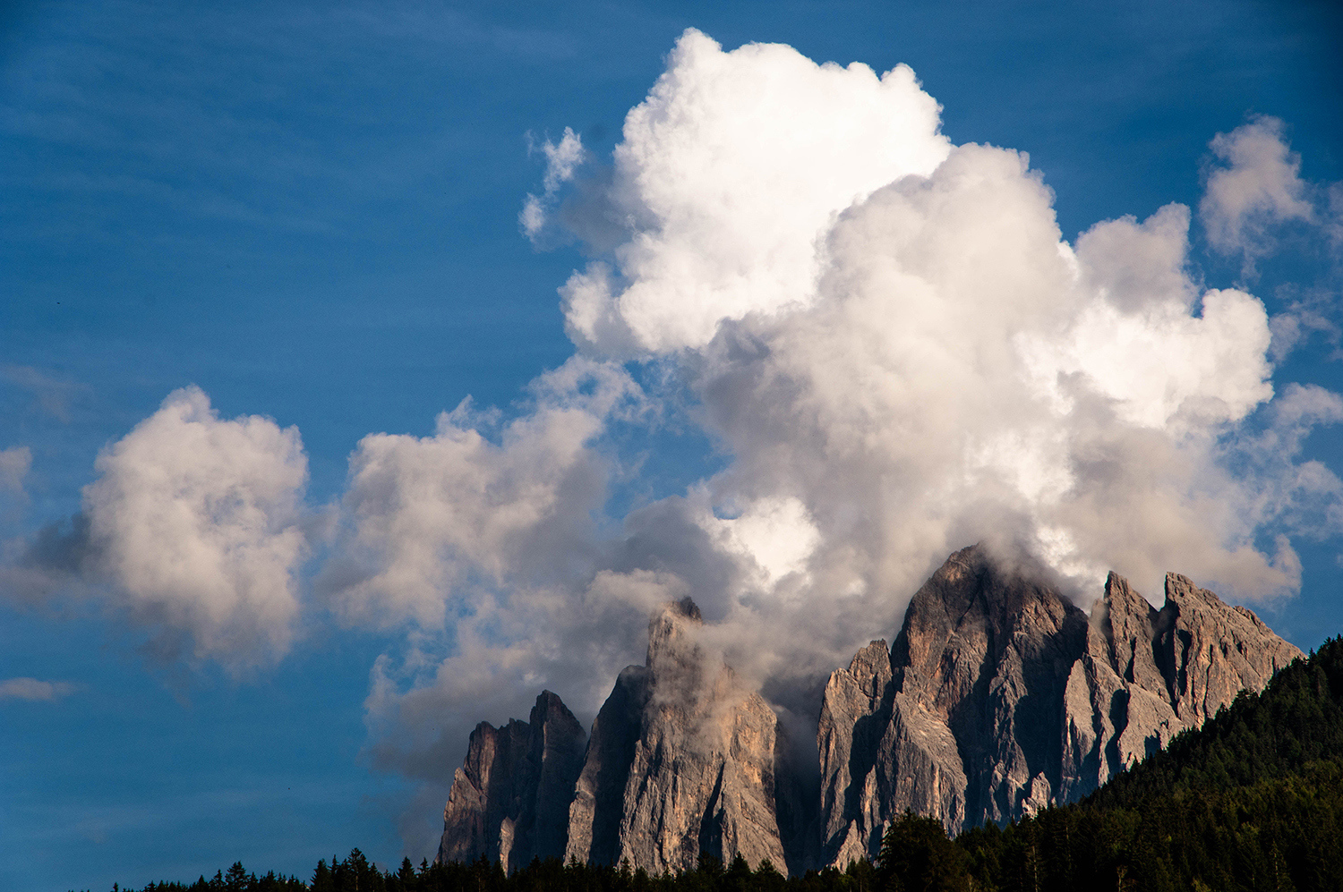<p>In the local Ladin language, these peaks are called Odle (needles), which does describe their steep, sharp peaks – here partly obscured by clustering clouds.</p>