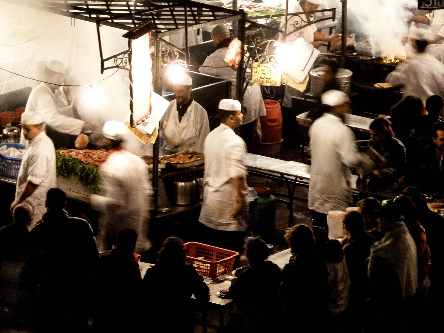<p>Marrakech's Jamaa el Fna is a central square that constantly whirls with activity. Here, cooks prepare meals at the lively food stalls.</p>