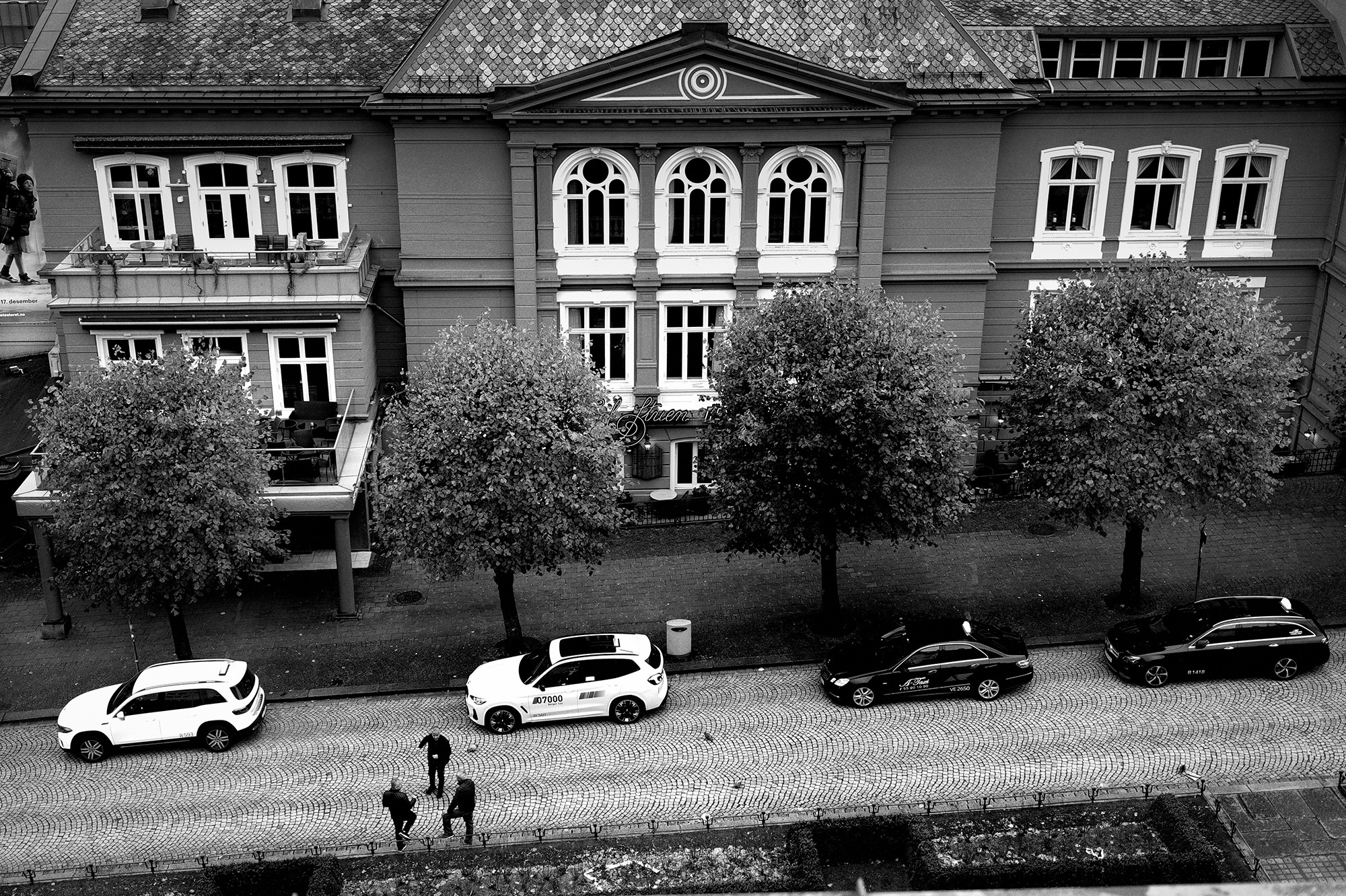 <p>A trio of taxi drivers chat while waiting for a fare.</p>