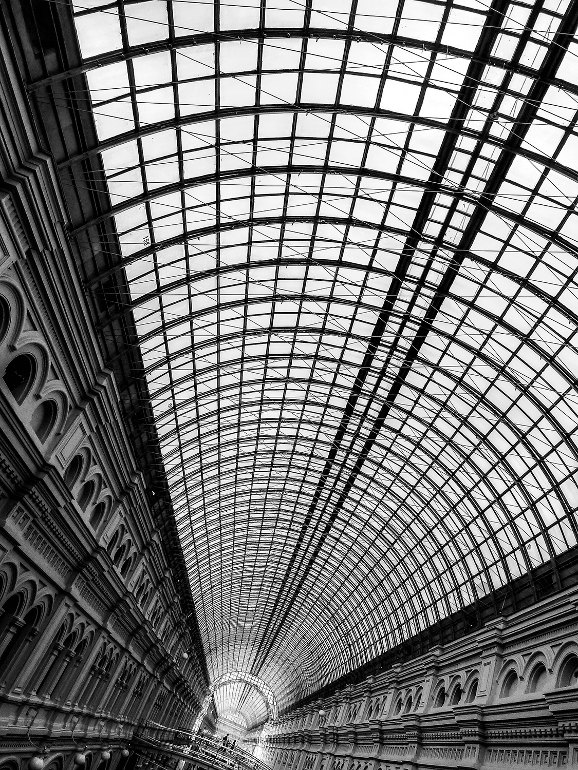 <p>Moscow's GUM runs the length of one side of Red Square. It dates from the late 19th Century, and was designed by Alexander Pomerantsev and Vladimir Shukhov. Shukhov in particular engineered this stunning glass roof, which covers several storeys of passages and created a climate-controlled shopping experience long before the suburban shopping mall concept. <br /></p><p>The name GUM, which stands for Main Universal Store (Главный универсальный магазин), was given to the facility during the Soviet period, and has stuck around since. Today, it really is a shopping mall – but with some serious architectural pedigree. </p>