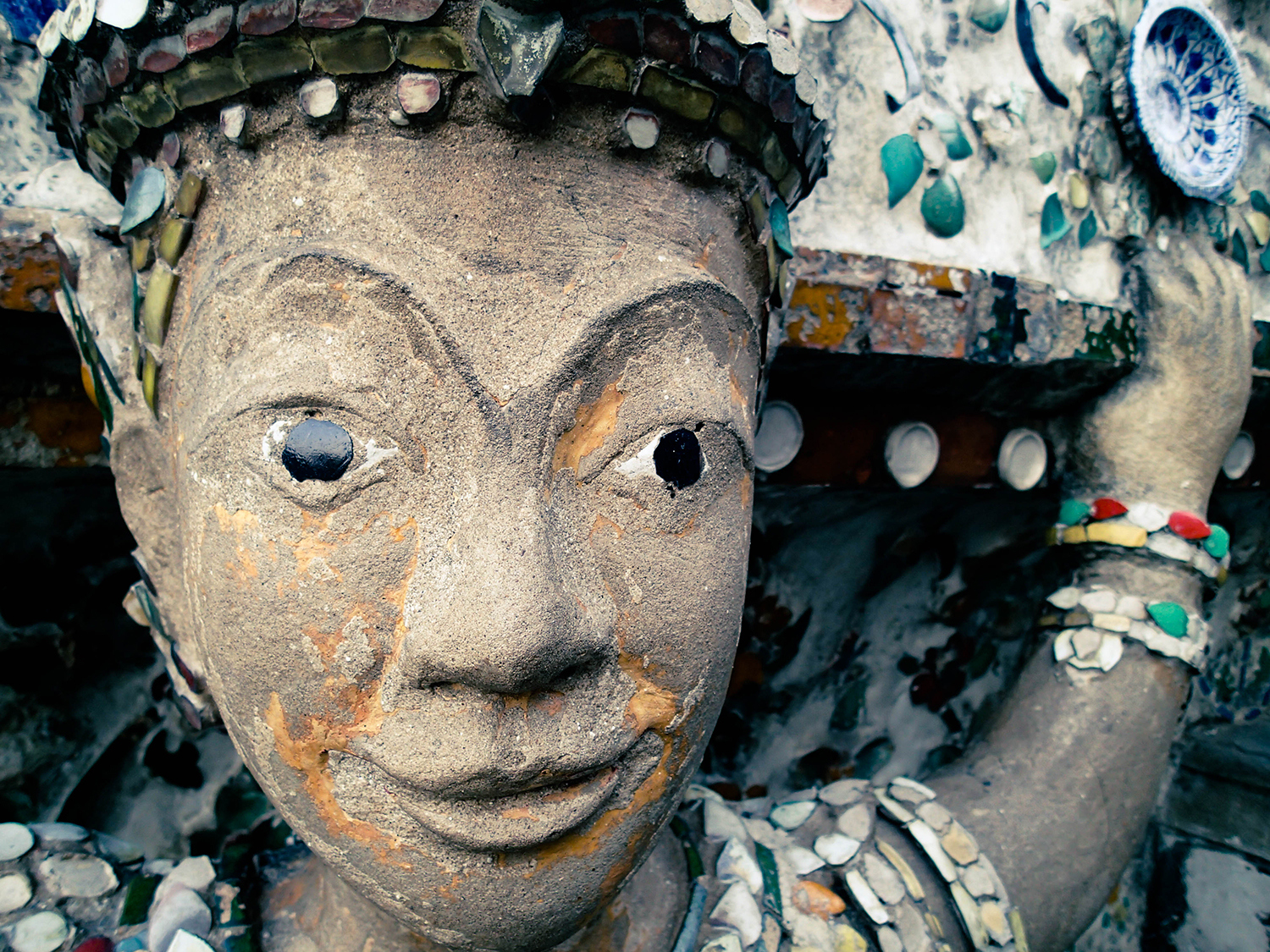 <p>A statue with a slight smirk at the Temple of the Dawn, Bangkok.</p>