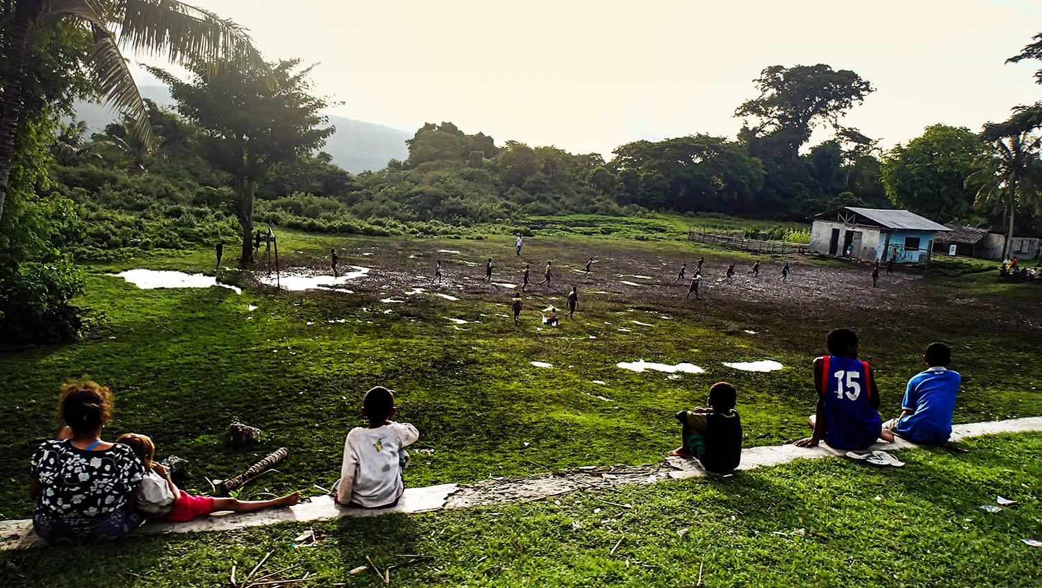 <p>A small crowd watches their neighbours playing football, somewhere in Timor-Leste's east. </p>