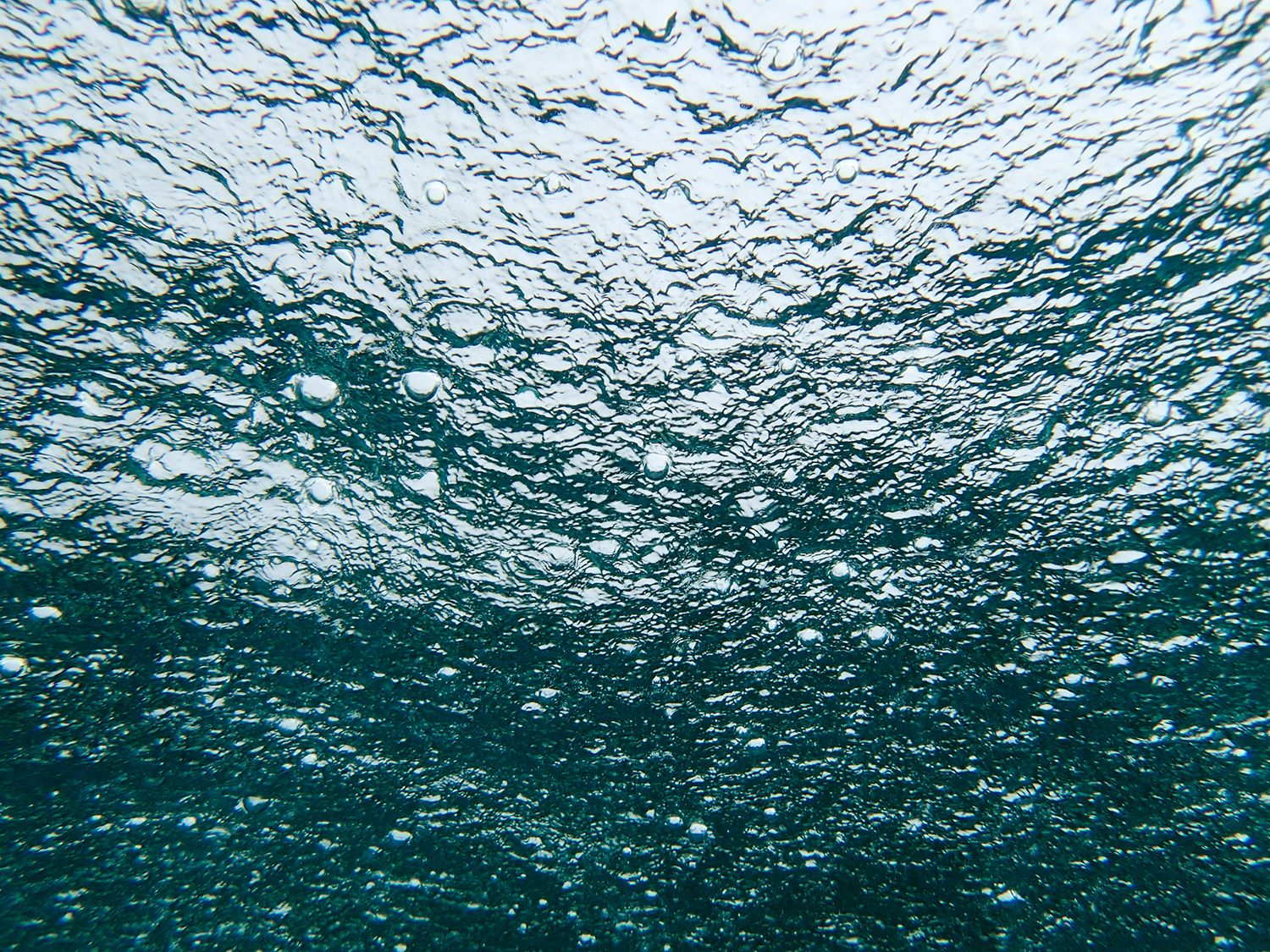 <p>Shot from beneath, raindrops ping the surface of the sea just off the sacred island of Jaco.</p>