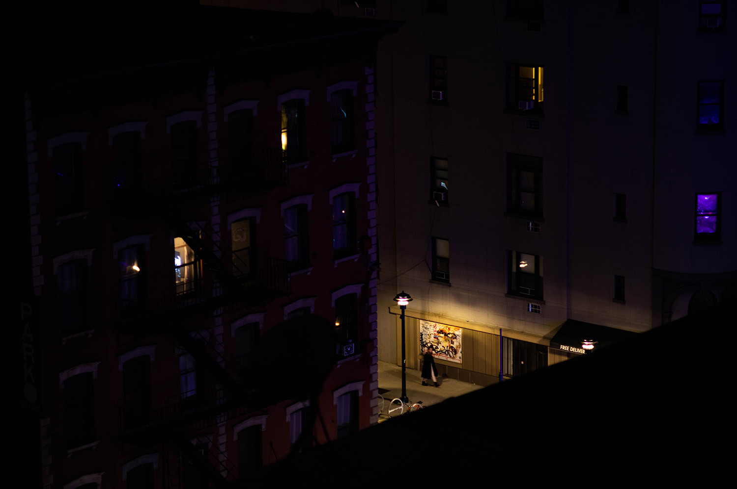 <p>A person out for a night stroll in Manhattan.</p>