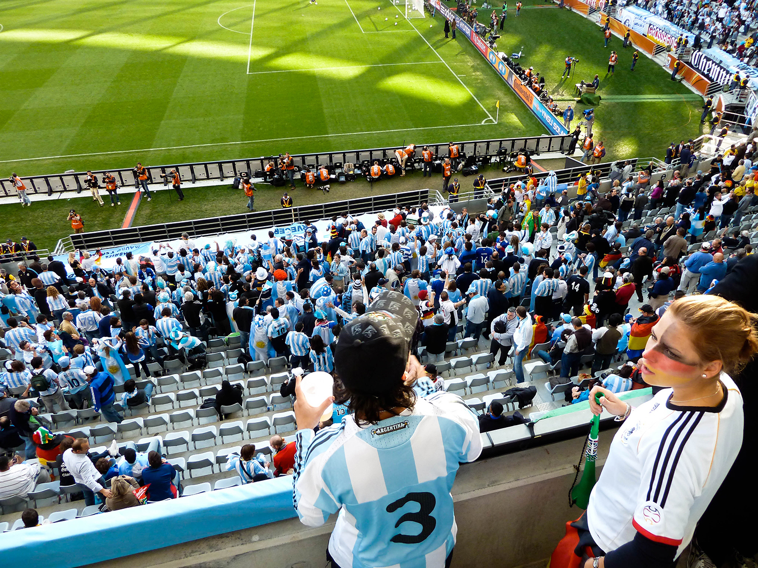 <p>A German fan is slightly outnumbered by Argentine hinchas before their quarter-final match in the 2010 World Cup. The match ended 0-4 to the Germans.</p>